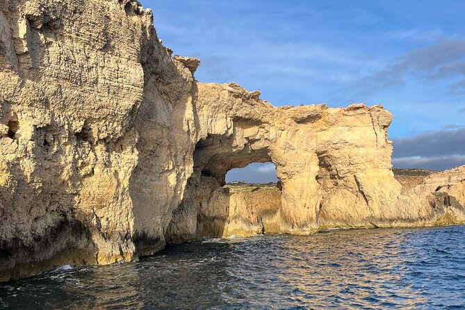 Blue Lagoon Ferry and Caves Tour - Leaving Mgarr under the blue umbrella