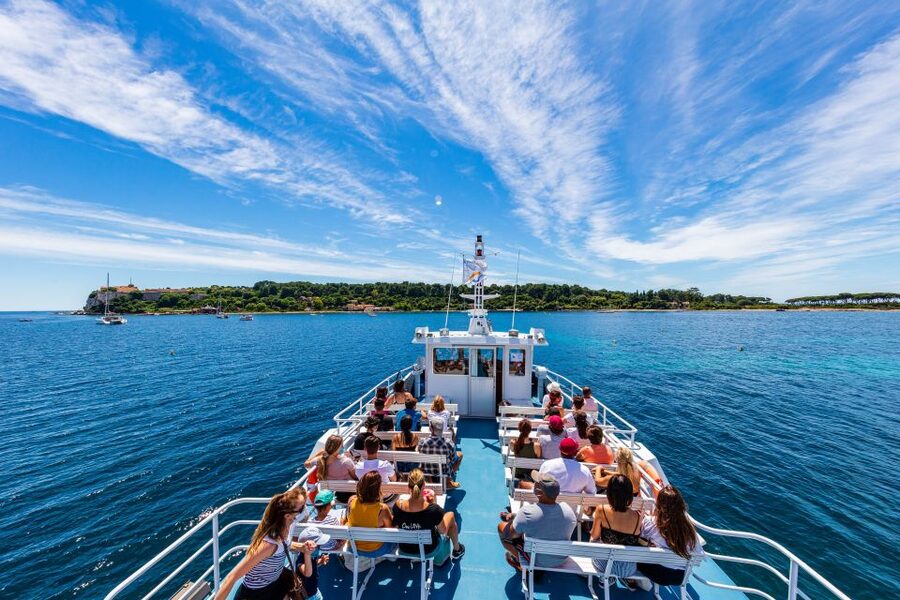 Passengers on the open forward deck of a ferry running out of Cannes