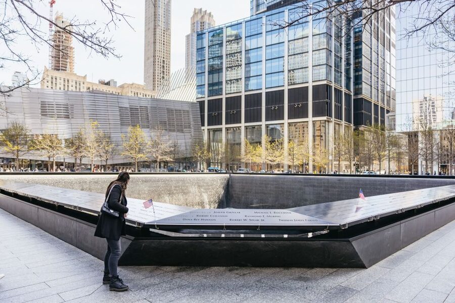 NYC: Wall Street Tour with 9/11 Memorial and Statue Ferry - Starting at Broad Street and entering the Financial District